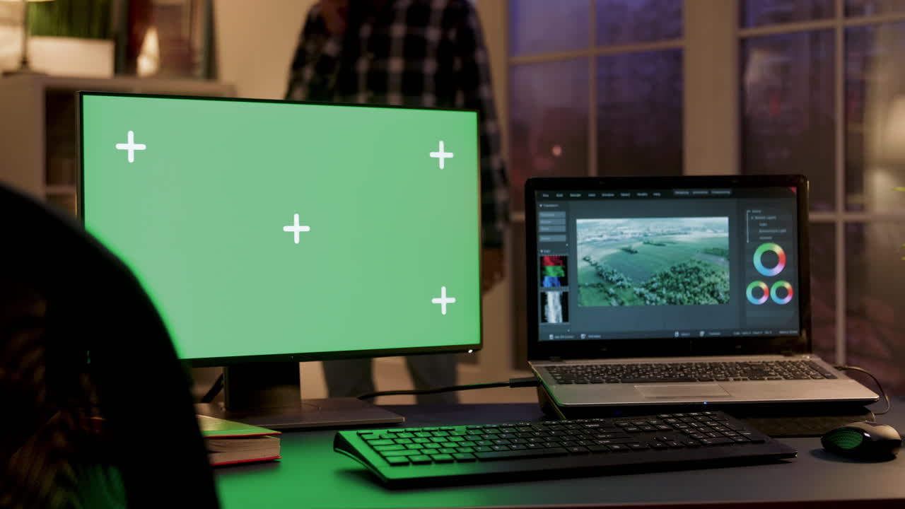 Workspace with Green Screen Monitor and Laptop