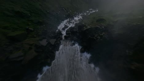 fpv flight over the tequendama falls flowing to rocky river in columbia