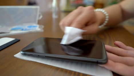 Crop-woman-cleaning-screen-of-smartphone