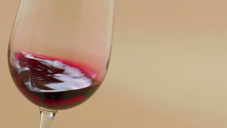 red wine swirling in an elegant wine glass