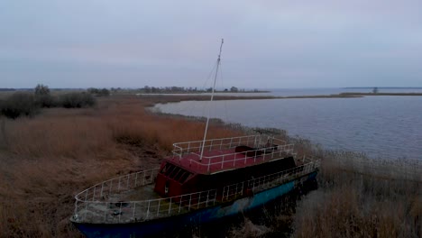 abandoned wrecked ship on grassy shore of dabie lake in szczecin, poland