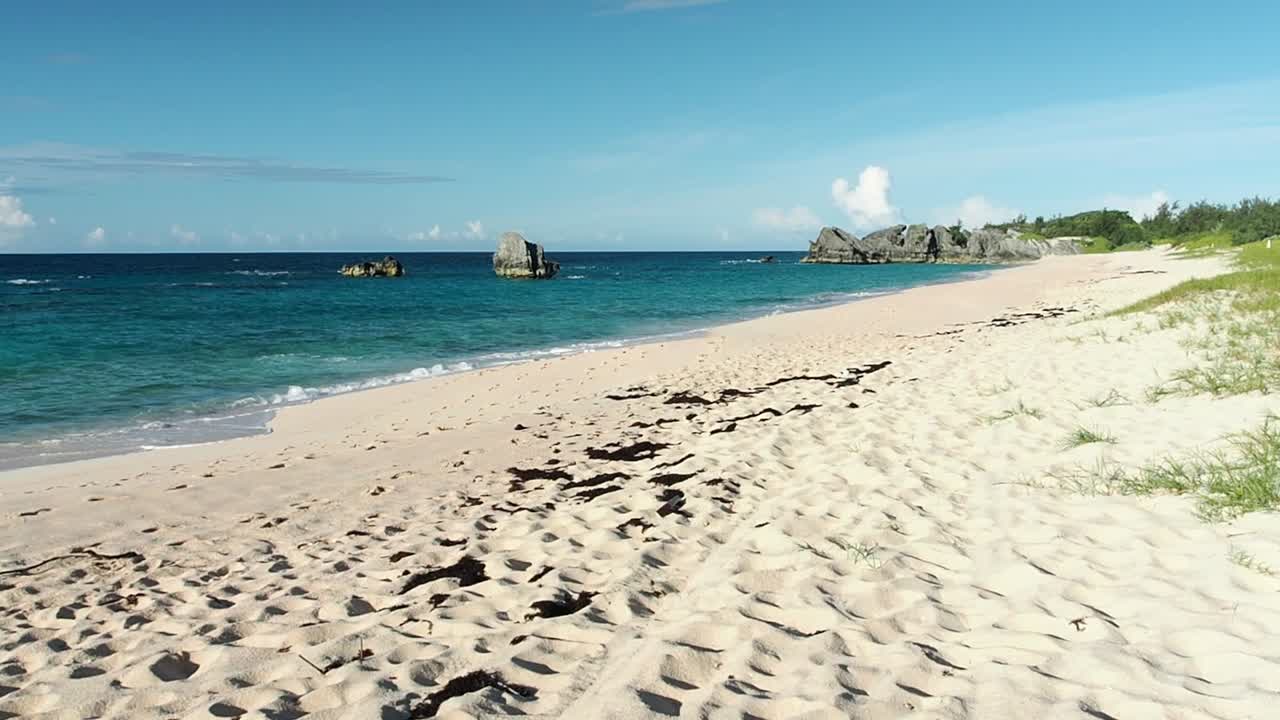 Warwick Long Bay beach is one of the longest beaches on the island of Bermuda. If has a rich colour of pink  sand, and different shade of blue that the ocean has displayed.