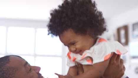 parents playing with young daughter at home