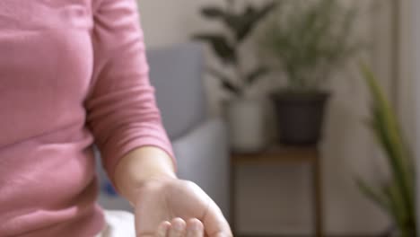 Woman-spraying-perfume-on-her-wrist-to-taste-the-fragrance-at-home