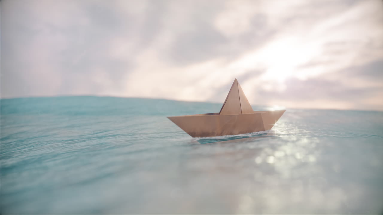 бумажная лодка, качающаяся в океане