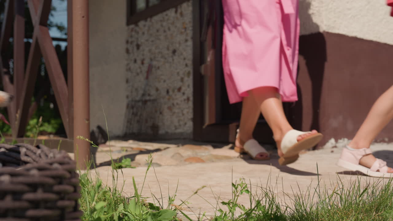 Corgi Dashing Out Of Doorway Toward Caucasian Children And Mother Sunny Front Yard, Wicker Lantern, Grassy Path, Excited Tail Wag, Joyful Reunion And Playful Sprint Across Cottage Steps