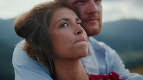 Young-family-feeling-happy-portrait.-Couple-cuddling-together-in-mountains.