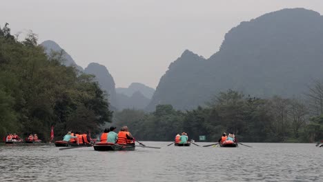 tourists rowing boats on a scenic river