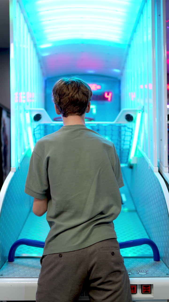 Teenager Playing Basketball Arcade Game