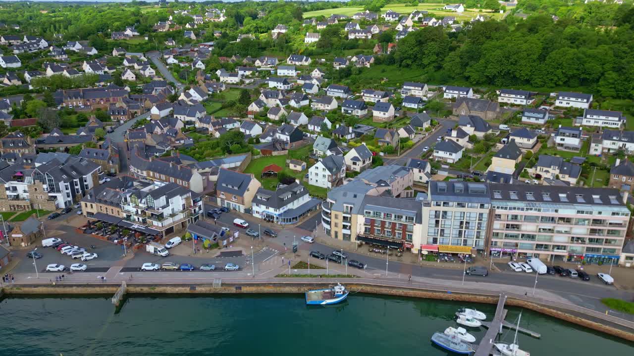 Vertically tilted drone movement over the local marina beside residential buildings at Perros-Guirec, Brittany, France.