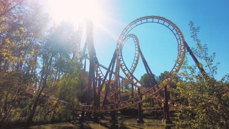 yellow red roller coaster looping in parc asterix on a sun flare fun summer day