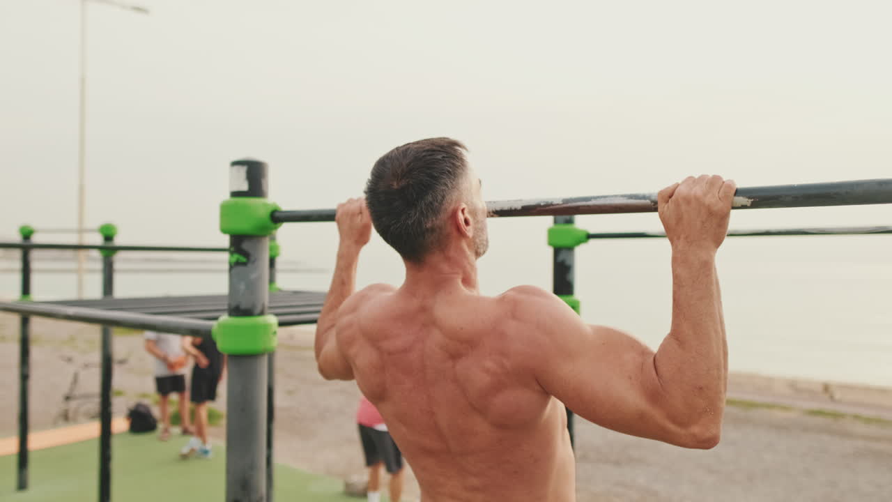 Man doing pull-ups outdoors for fitness and strength training