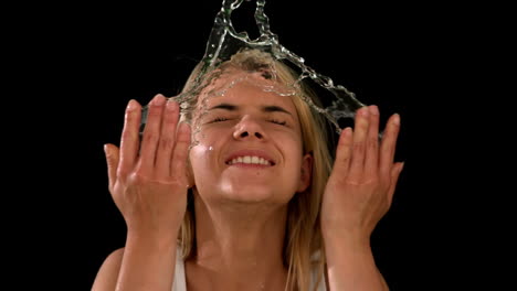 pretty blonde splashing her face