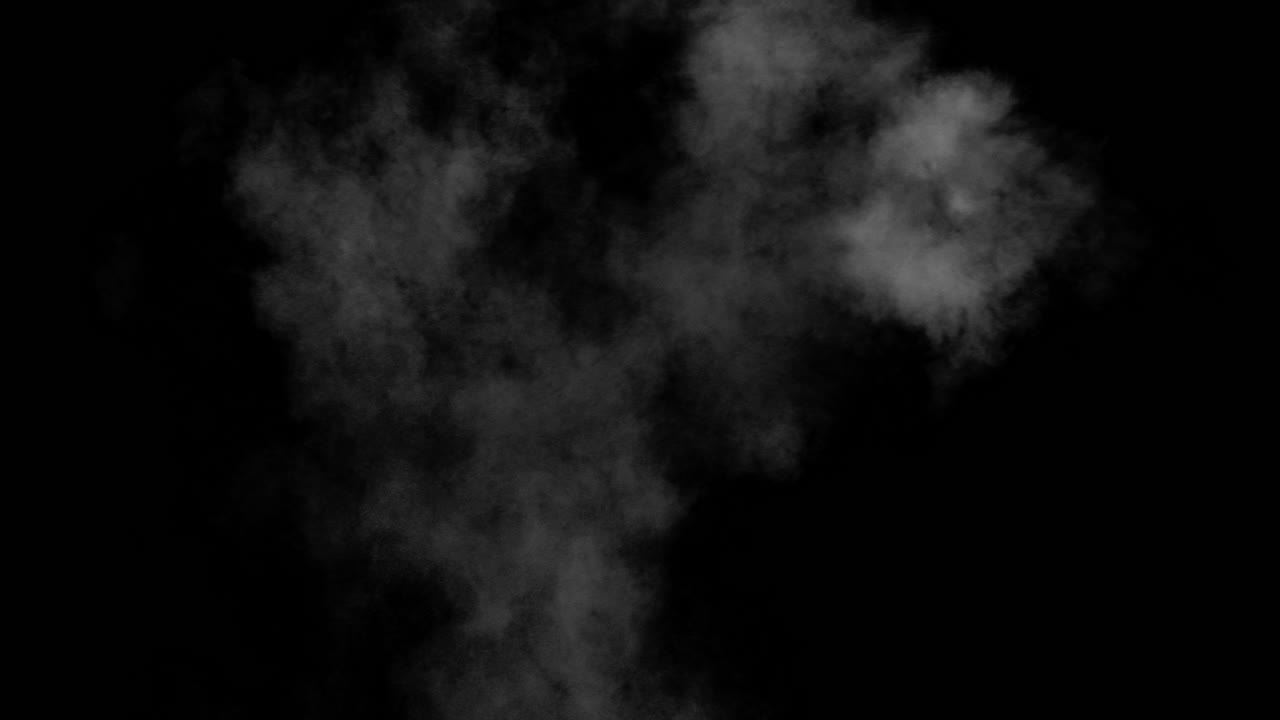 Piccole nuvole di polvere fuoriescono dal lato destro dello schermo e si spostano verso il centro dello schermo su sfondo nero.