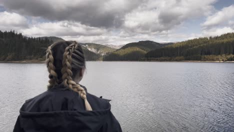 Bolboci,-Romania---A-Woman-Appreciating-the-Picturesque-Vista-of-the-Lake---Drone-Flying-Forward