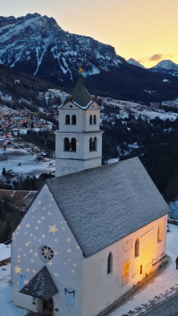 Aerial drone view of the Eglise de Sainte-Lucie in the Colle Santa Lucia comune in Dolomites, Italy. Vertical