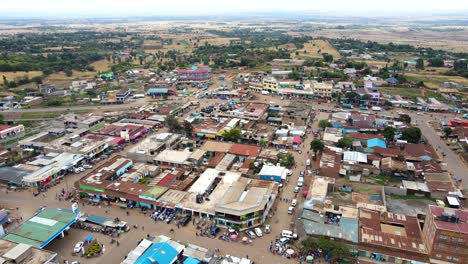 aerial view of cars and people at a open air market, in africa - reverse, drone shot