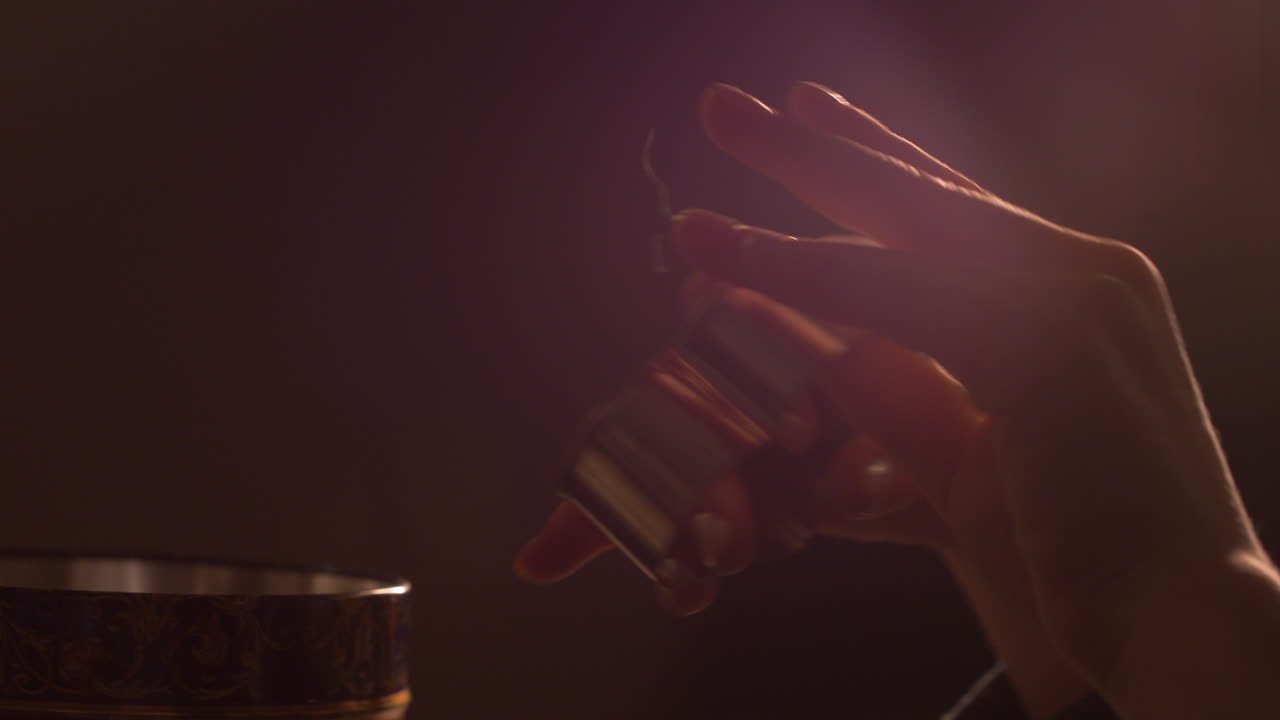 Close up, young child's hand holding heart shaped cookie cutter. Ambient light