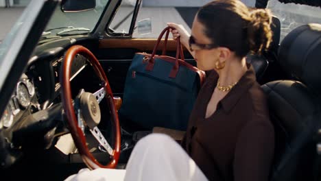 woman in a vintage convertible