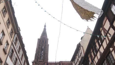 panning up at the tallest cathedral in europe in strasbourg, france at a festive christmas market in europe