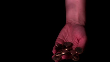 Money-falling-into-hands-on-black-background