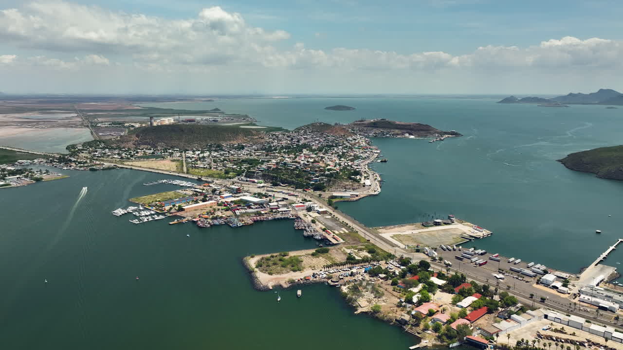 Drone flying backwards over the Topolobampo village, sunny day in Sinaloa, Mexico
