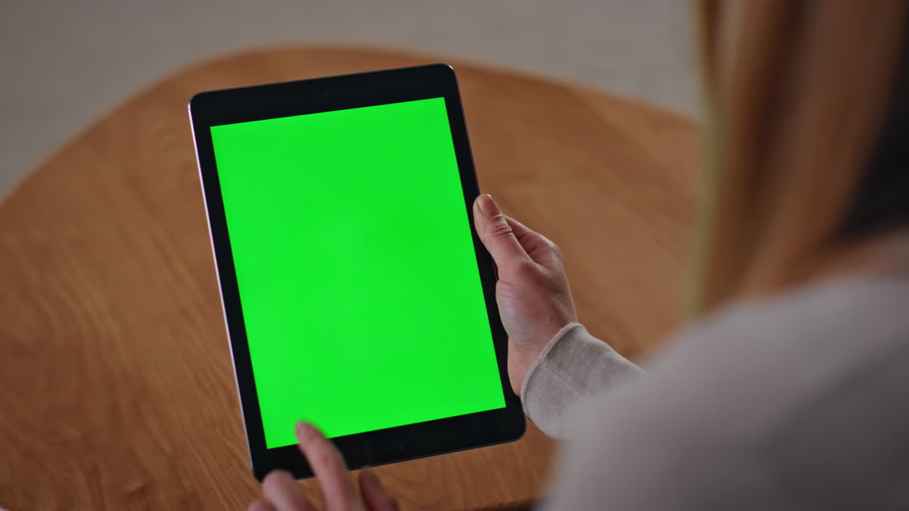 Girl hands scrolling green screen tablet watching news feed social media closeup