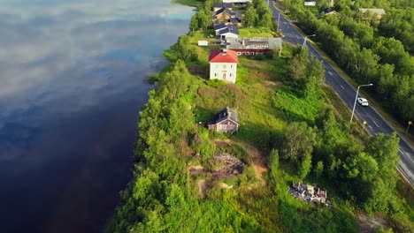 Road-trip-on-Long-highway-parallel-to-Tornio-river-glossy-water,-Finnish-Swedish-border,-tracking-shot