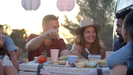 Amigos-Hablando-En-Un-Picnic-Junto-A-Su-Autocaravana.