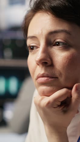 vertical video software developer monitoring server clusters performing ai training, close up