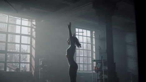 sports woman warming body before workout in gym. girl preparing for cardio