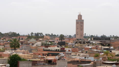 towering minaret of kutubiyya mosque in the city skyline of marrakesh in morocco, north africa