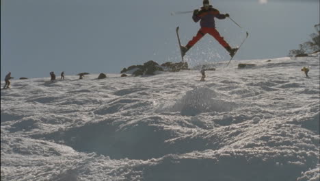 skier jumping from the edge of a snow ridge