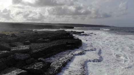 aerial of beautiful irish coastline with black rocks and moody look