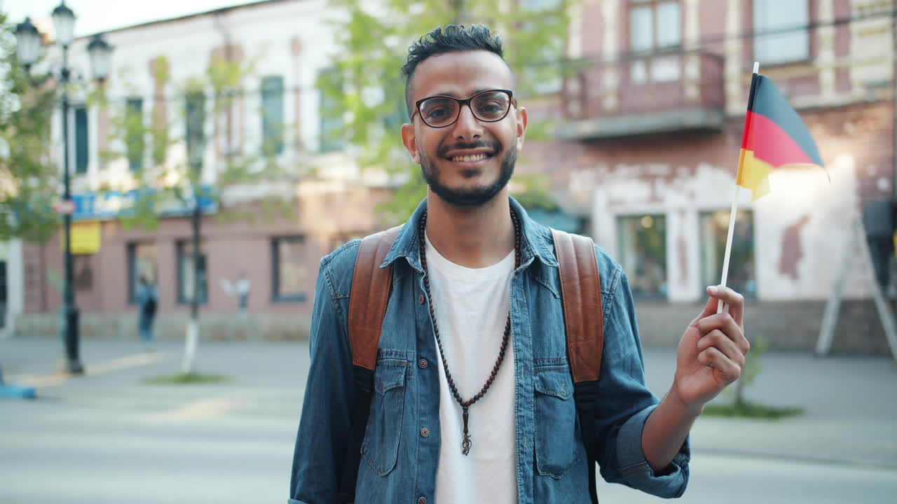 Man holding German flag in a city street