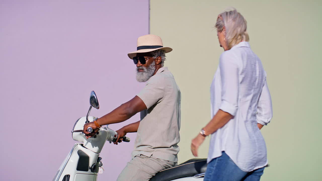 Senior couple riding a scooter