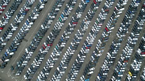 many cars on a parking lot from above, filmed with a drone in 4k