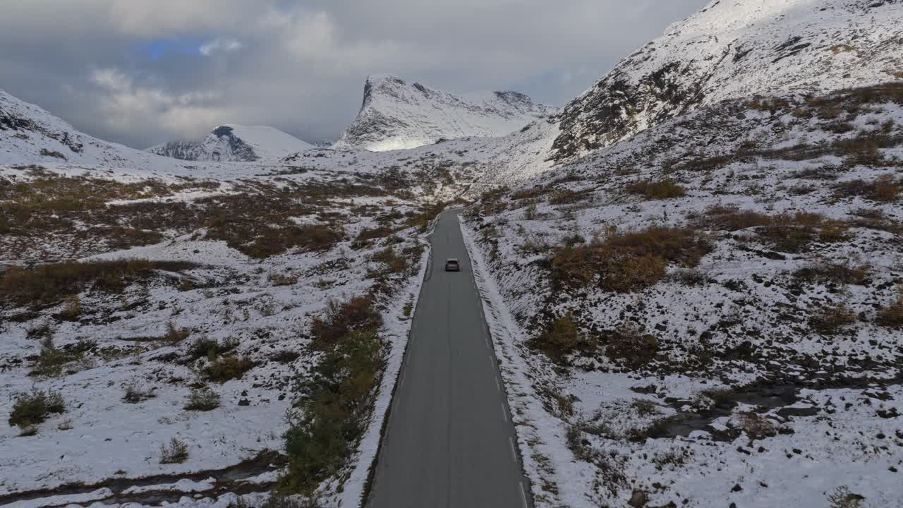 Aerial capture of lone car in winter wilderness, Norway