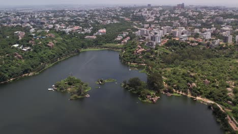 Aerial-video-of-Durgam-Cheruvu-Lake,-also-known-as-Raidurgam-Cheruvu,-is-a-freshwater-lake-located-in-Rangareddy-district,-Jagathgiri-Gutta-Telangana,-India