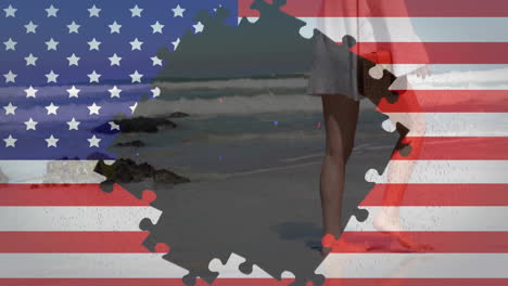 animation of flag of usa with puzzle pieces over caucasian woman walking on beach