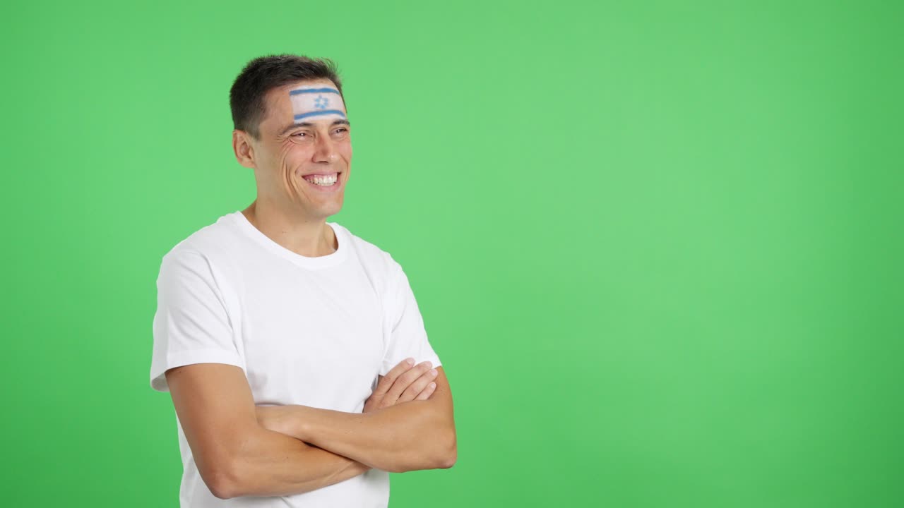 Happy man with israeli flag painted on face looking away
