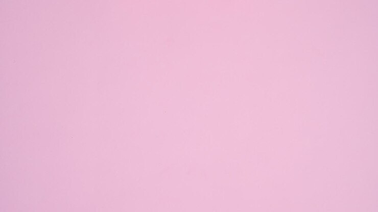 Colorful candies, sweets, lollypops, chocolates appear on pastel pink theme. Stop motion flat lay