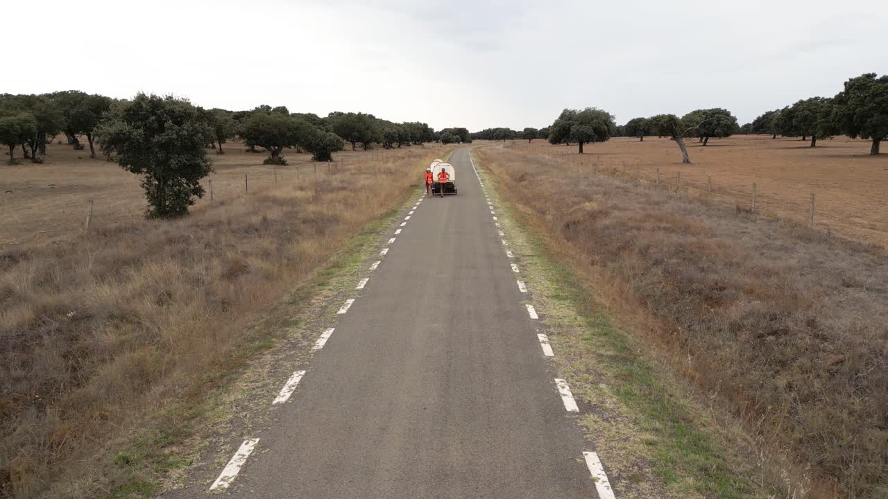 Nomad family pulling small homes on wheels in countryside in Spain