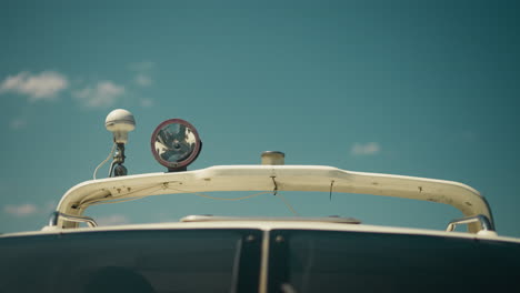 lamp and sound signal device on hardtop of modern motor boat under clear sky closeup. upper parts of sailboat on sunny day. yacht equipment