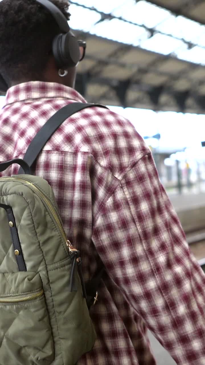 Man with Backpack at Train Station