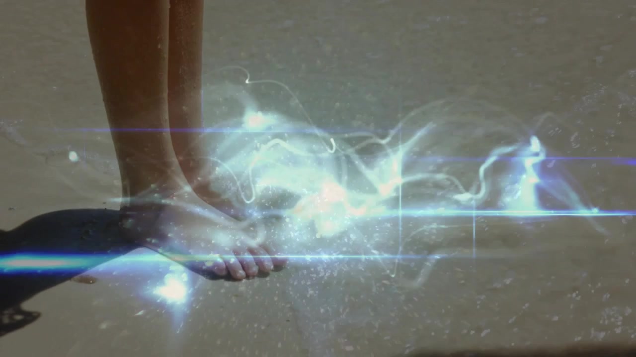 Child shifting weight on wet sand as blue-white ribbons appearing near toes, demonstrating AR tech