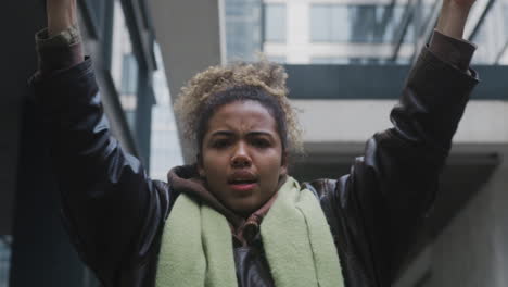 Portrait-Of-A-Young-American-Climate-Activist-Holding-A-Placard-And-Protesting-To-Save-The-Earth-While-Looking-At-Camera