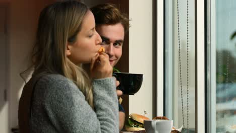 couple interacting while having food in cafe 4k