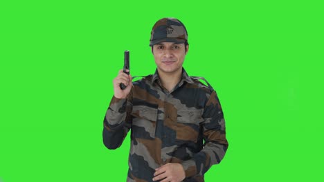 indian army man posing with gun green screen