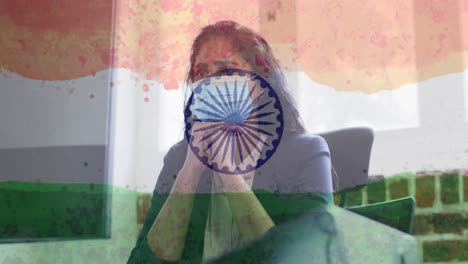 composition of woman wearing face mask in office over indian flag